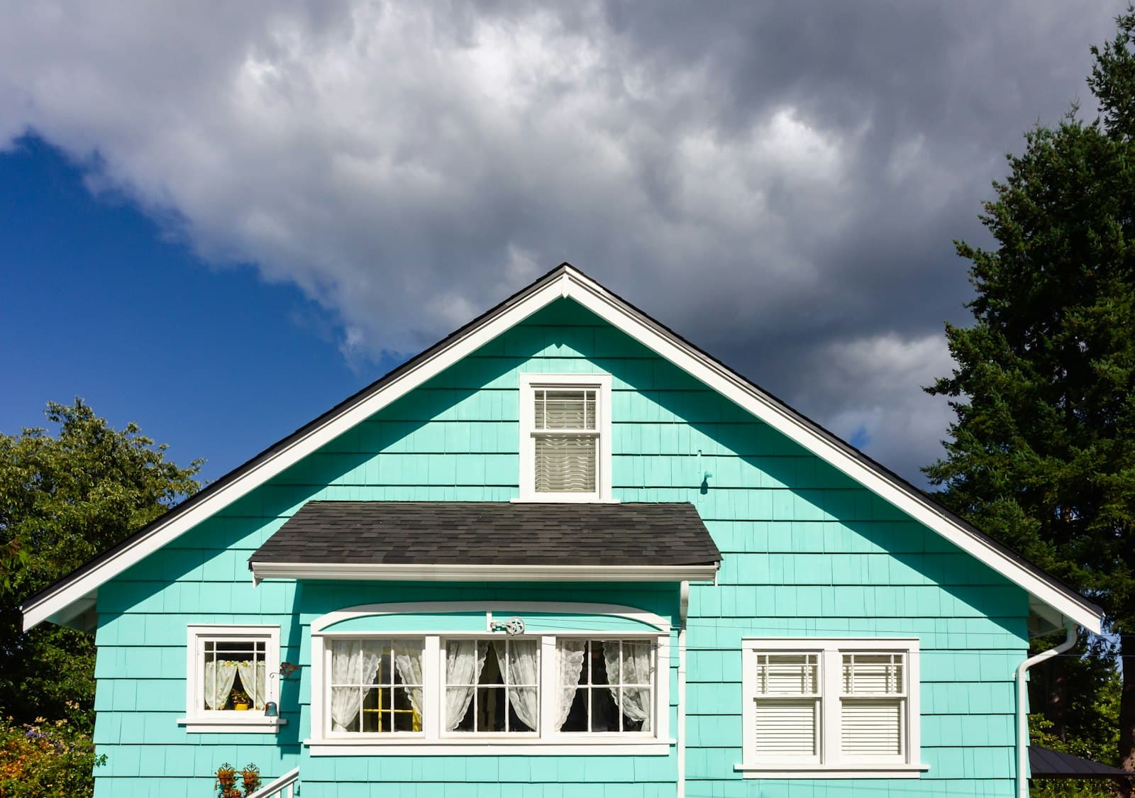 Blue sided house with white trim